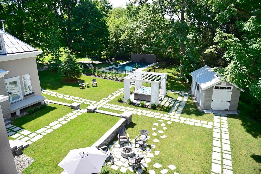 Manicured grounds with pool, hot tub, and fire pit seating