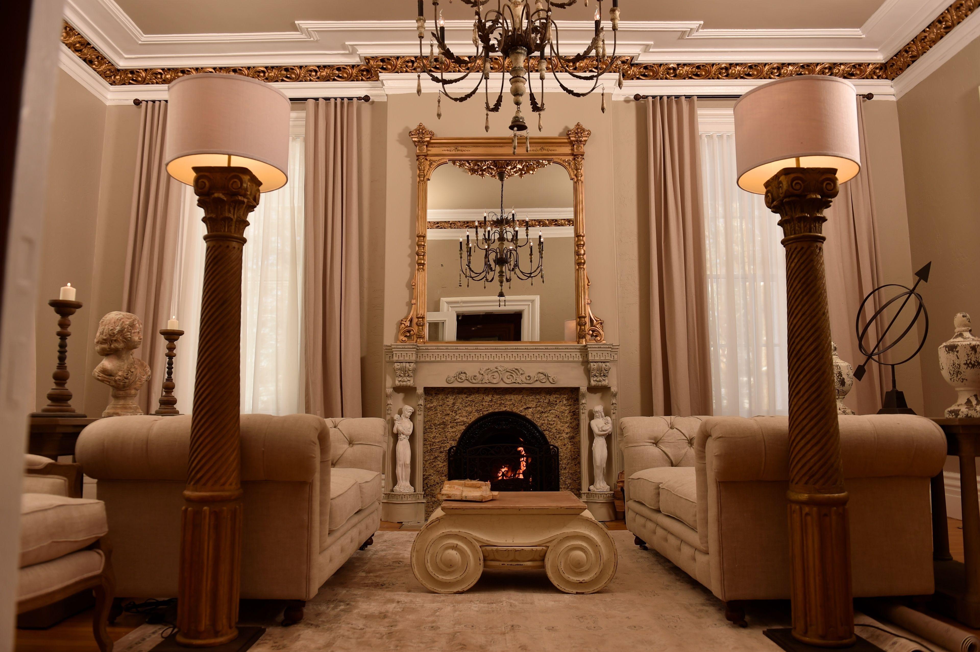 Grand lounge with ornate fireplace and column lamps